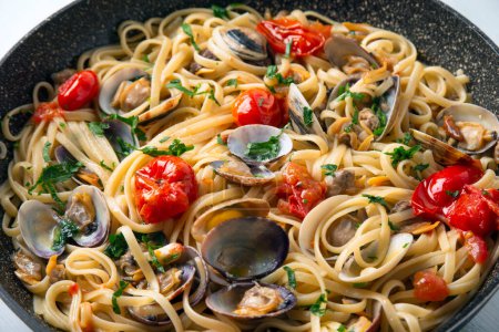 Photo for Delicious linguine with clams and cherry tomatoes, italian cuisine - Royalty Free Image