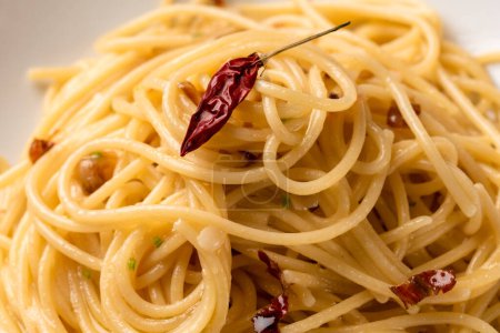 Téléchargez les photos : Assiette de délicieux spaghettis typiques à l'huile d'olive, ail et chili, pâtes italiennes - en image libre de droit