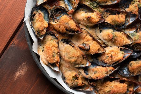 Photo for Delicious mussels breaded and baked au gratin, italian food - Royalty Free Image