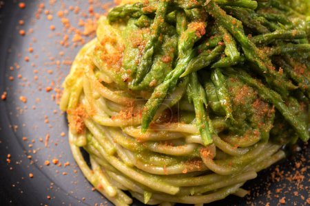 Delicious gourmet spaghetti with wild asparagus cream and bottarga, Italian food