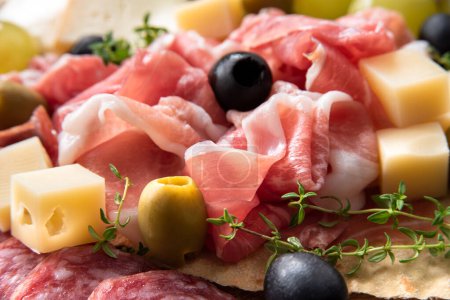 Photo for Tray of delicious italian foods - prosciutto crudo, cheese, walnuts and fresh figs - Royalty Free Image