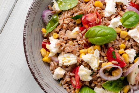 Photo for Delicious spelt salad with mozzarella and vegetables - Royalty Free Image