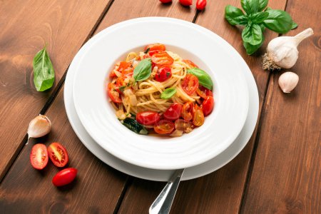 Photo for Dish of delicious spaghetti with olive oil, basil and datterini tomatoes, italian food - Royalty Free Image