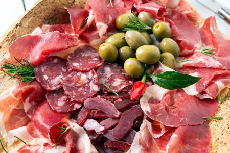 Foto de Aperitivos mediterráneos con carne curada, salchichas y aceitunas - Imagen libre de derechos