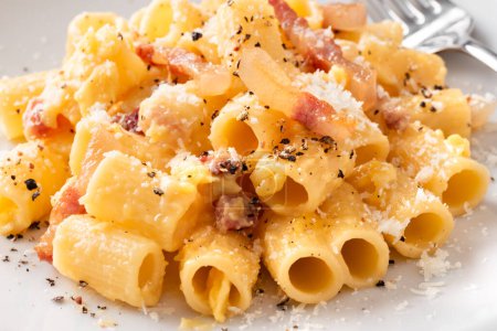 Photo for Pasta alla carbonara, a traditional roman recipe of pasta with egg, guanciale, pecorino and black pepper, italian cuisine, european food - Royalty Free Image