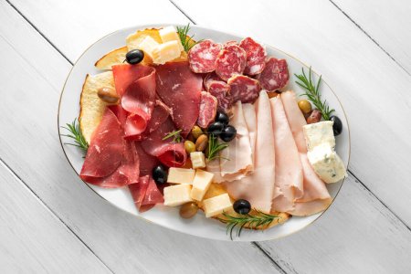 Photo for Delicious snacks, meat, cheese, olives - Royalty Free Image