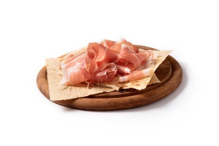 Photo for Sliced prosciutto crudo on wooden board, typical italian food - Royalty Free Image