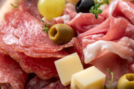 Photo for Platter with prosciutto crudo, pecorino, olives and sausage, rustic italian appetizers - Royalty Free Image