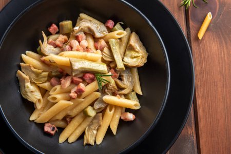 Photo for Delicious penne lisce with pancetta and artichokes, Italian pasta - Royalty Free Image