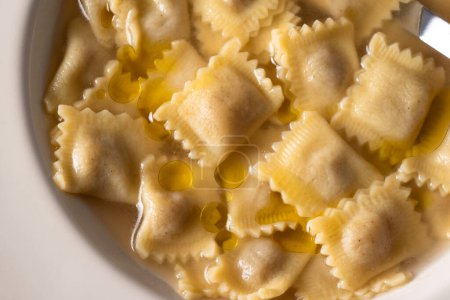 Photo for Plate of ravioli stuffed with veal in broth, Italian Cuisine - Royalty Free Image