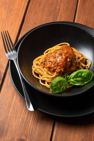 Photo for Close-up shot of delicious spaghetti with tomato sauce and basil - Royalty Free Image