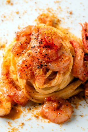 close-up shot of delicious pasta with shrimps on white plate