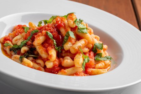 Photo for Plate of delicious cavatelli with tomato sauce, traditional italian pasta - Royalty Free Image