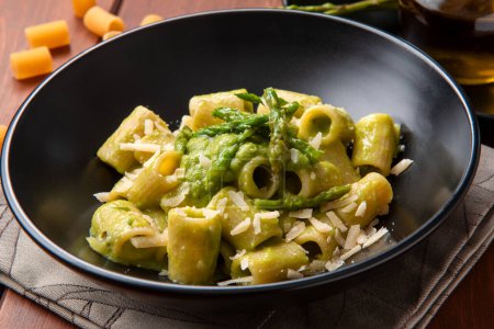 Photo for Plate of delicious macaroni with wild asparagus sauce, italian pasta, mediterranean food - Royalty Free Image