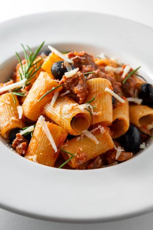 Photo for Dish of mezze maniche pasta with sausage, tomato sauce and grated cheese - Royalty Free Image