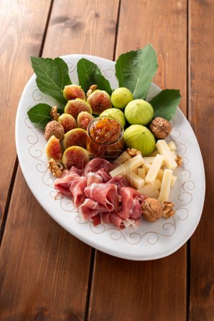 Photo for Tray with delicious italian foods. fresh prosciutto, pecorino, jam and fresh figs - Royalty Free Image