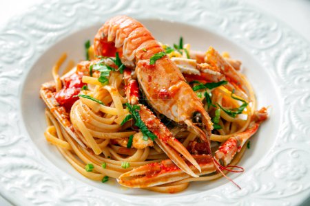 Photo for Close-up shot of delicious seafood pasta with lobster in white plate - Royalty Free Image
