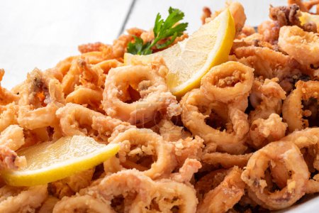 Closeup of fried squid rings tray, Italian food, Mediterranean snack