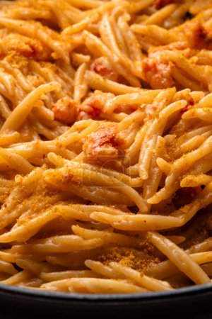 Closeup of delicious trofie with shrimp sauce and bottarga, italian pasta, european food