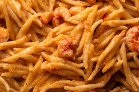 Closeup of delicious trofie with shrimp sauce and bottarga, italian pasta, european food