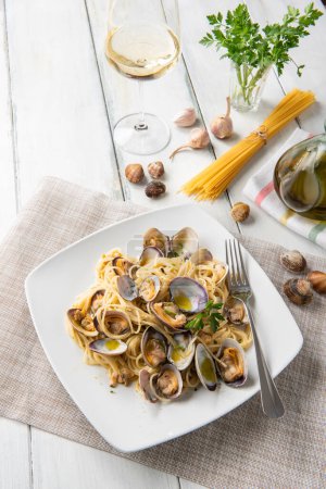 Plate of delicious spaghetti with mussels, clams and bottarga, Italian food