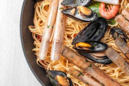 Pan with delicious spaghetti with seafood sauce, mediterranean food, italian pasta