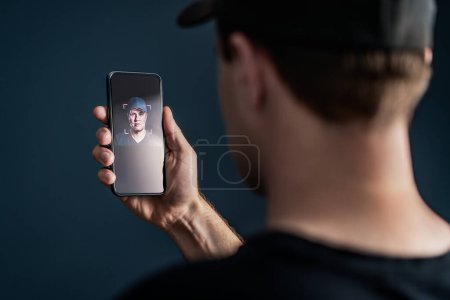 Photo for Face recognition with facial scan in phone. Identification and verification to unlock smartphone. Deep fake technology. Man using cellphone. AI mobile tech and biometric id authentication. Data access - Royalty Free Image