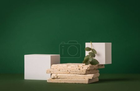 Photo for Product presentation mockup scene made with travertine tiles, white cubes and eucalyptus branch on a green background. Front view, copy space. - Royalty Free Image