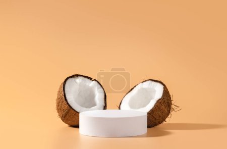 Photo for Cosmetic product design. White circle mockup podium and coconuts for beauty product presentation. Front view. - Royalty Free Image