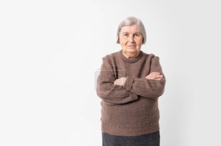 Foto de Old woman. 80 years old grey haired elderly woman on white background with copy space. - Imagen libre de derechos