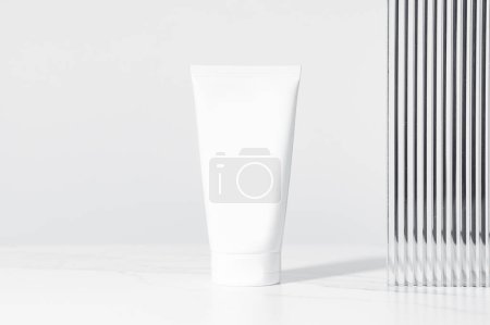 Minimal composition of white plastic mockup cosmetic or cream tube. Studio photography.