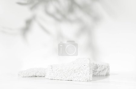 Photo for Neutral white product presentation podium and display made with porous stones on white background. Studio photography. - Royalty Free Image