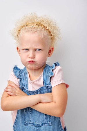 Photo for Offended girl put hands one by one. cute child is offended and angry. Girl on white background. caucasian curly blonde kid looking at side copy space with with pouty lips. children and human emotions - Royalty Free Image