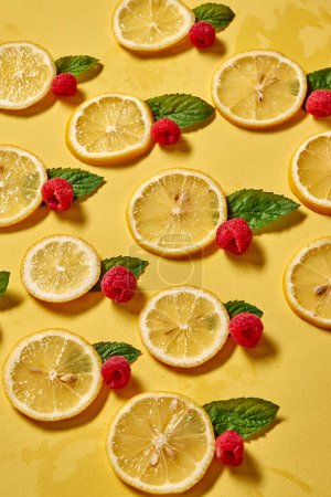 Téléchargez les photos : Creative shot of summer tropical fruits, lemon and raspberry on yellow background. Nutrition concept. Flat lay, top view, copy space - en image libre de droit