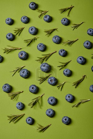 Foto de Slices of ripe blueberries isolated on green background. copy space. top view. flat lay - Imagen libre de derechos
