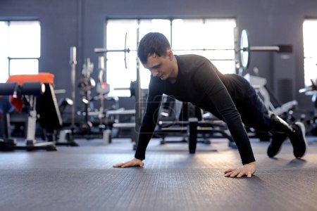 Photo for Love of life. cross fit. active strong man performing push-up on the floor. hobby, free time, spare time, health and body care - Royalty Free Image