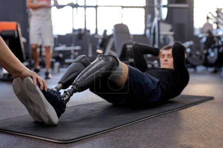 Photo for Love of life. free time, spare time, lifestyle. motivation,side view full length shot, keep fit. hardworking active guy lying on the floor, bending his knees and doing exercise for abs. willpower - Royalty Free Image