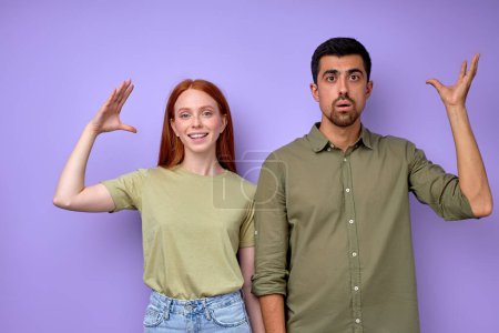 Photo for Young deaf mute couple with gestures hands palms saying stupid closeup portrait isolated blue background - Royalty Free Image