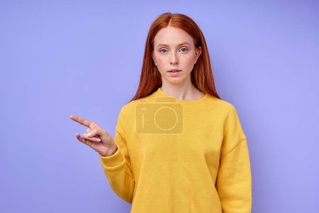 Photo for Beautiful redhead girl, teacher showing letter Z on blue background. Sign language alphabet. free education for deaf children, girl demonstarting three fingers - Royalty Free Image