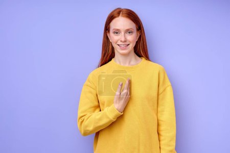 Photo for Smiling ginger girl pointing to herself, I, me closeup portrait isolated blue background Really - Royalty Free Image