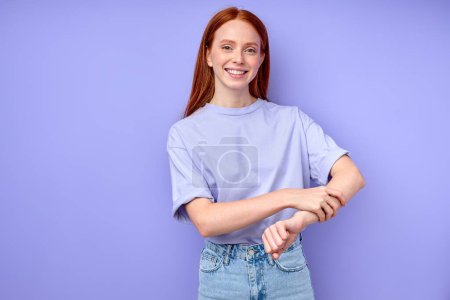 Photo for Awesome happy girl touching her arm, keeping it, isolated blue background studio shot closeup portrait - Royalty Free Image