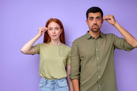 Photo for Young deaf mute couple with hands gestures saying clever closeup portrait isolated blue background - Royalty Free Image