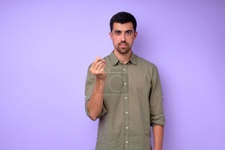 Photo for Young deaf mute man asking money using sign language on blue background, close up portrait isolated - Royalty Free Image