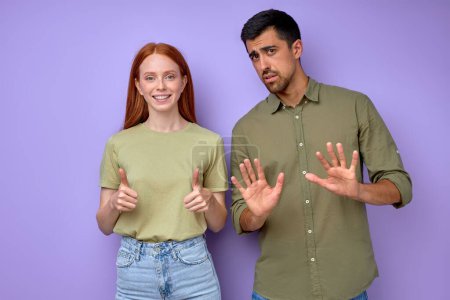 Photo for Happy attractive red-haired girl saying she is ok, bearded man saying that he is bad, close up portrait isolated blue background different feelings and emotions - Royalty Free Image
