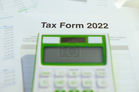 Photo for Tax form 2022 and calculator at desk. - Royalty Free Image