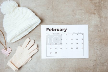 Photo for Winter flat lay with gloves and february calendar. - Royalty Free Image