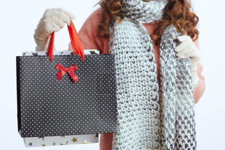 Photo for Hello winter. Closeup on stylish middle aged woman in sweater, mittens and scarf with shopping bags isolated on white background - Royalty Free Image