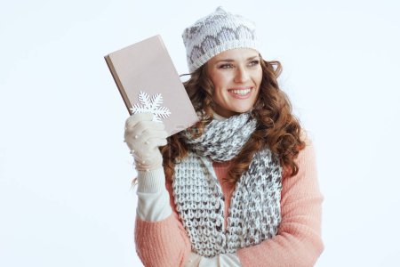 Photo for Hello winter. happy trendy woman in sweater, mittens, hat and scarf isolated on white background with snowflake and book. - Royalty Free Image