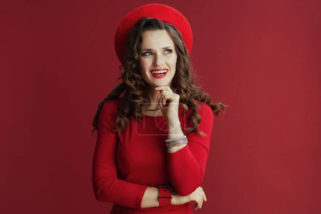 Photo for Happy Valentine. smiling modern female with long wavy hair in red dress and beret isolated on red. - Royalty Free Image