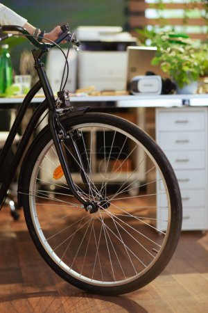 Foto de Closeup on business woman with bike in eco office. - Imagen libre de derechos